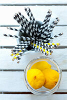 Straws and lemons as utensils and ingredients for drinks