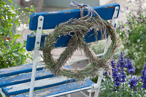 Pretzel made from grass blossoms on the back of the chair