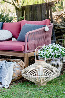 Sofa, planters and planted basket in spring garden