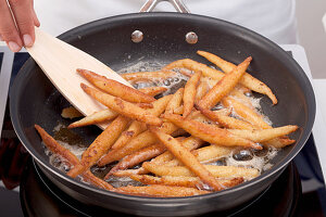 Finger pasta being fried in butter
