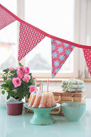 Birthday table with cake with candles, garland and roses