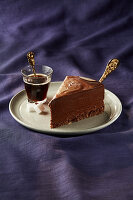 A piece of chocolate mousse cake with coffee