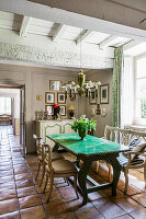 Table with green glazed ceramic top in dining room