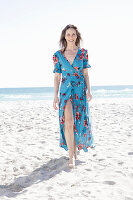Langhaarige Frau im Sommerkleid am Strand