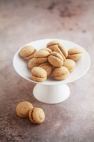 Baci di dama (Italian hazelnut biscuits) on a cake stand