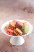 Various colourful macaroons on a cake stand