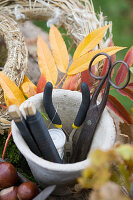 Pot with wreath tying tools: winding wire, scissors, and wire cutters