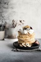 Pancakes with whipped cream and bananas