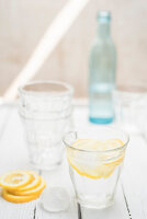 Fresh water in a glass with ice cubes and lemon slices