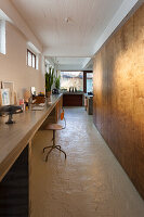 Long concrete slab used as desk in renovated loft apartment