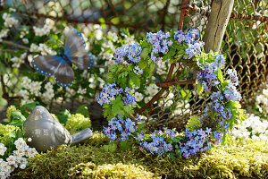 Spring wreath made of forget-me-not flowers and cranesbill leaves