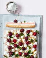 Cream slices with fresh cherries, pistachio nuts and mint