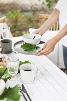 Woman setting the table on the terrace