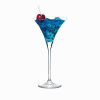 Blue cocktail in martini glass with ice cubes and a cherry garnish