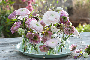 Small bouquets of ranunculus and spring roses