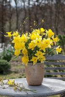 Bouquet of daffodils and cornelian cherry branches