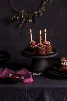 Chocolate cupcakes with lit candles