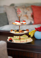 Sandwiches and pastries on a dessert stand at tea time