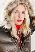 Blonde woman in winter jacket with fur hood
