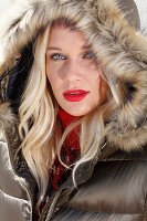 Blonde woman in winter jacket with fur hood