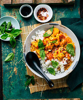 Spicy pumpkin curry with coconut milk served over rice (vegan)