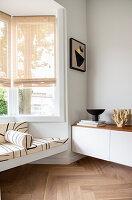 Black and white bench in the bay window in the minimalist living room