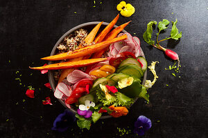 A veggie bowl with edible flowers