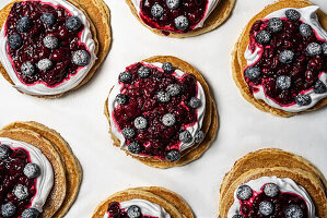 Pancakes with cream and berry compote topping