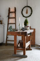 Wooden workbench with candles and Christmas decorations