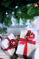 Christmas presents with red bows and toadstools under a decorated Christmas tree