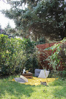 Yellow picnic blanket with cushion and wooden box in garden