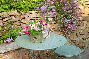 Small bouquets of flowers on metal table in the garden