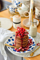 Chocolate pancakes with red currants