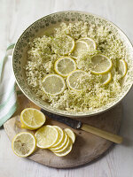 Elderflowers with lemon slices steeped in water