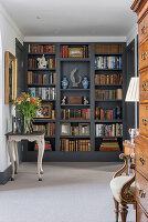 Bookshelf with decorations in classically furnished living room
