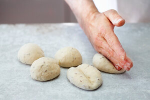 Rolls being shaped by hand