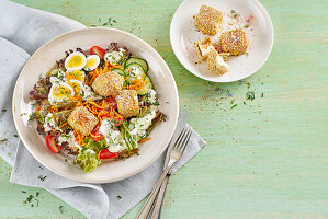 Sheep's cheese in a sesame coating on a mixed salad