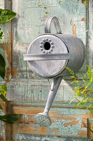 DIY bird nesting box made from a watering can