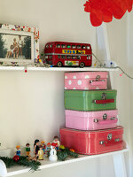 Assorted suitcases and toys on shelves in child's room of family home, France