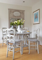 Dining area with country style white wooden table and chairs