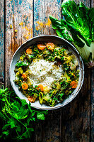Asian coconut wok vegetables with peanuts and rice