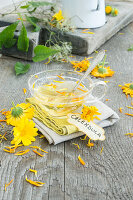 Marigold tea (Calendula officinalis), with fresh flowers and petals