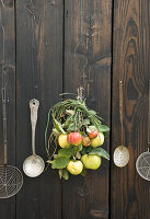 Bouquet of quinces and apples on wooden door with kitchen utensils