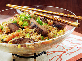 Pork Fried Rice in a glass bowl with chopsticks