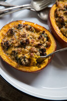 Stuffed pumpkin with sausage, spinach and cheese