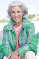 Gray-haired woman in a green coat