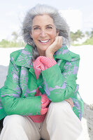 Gray-haired woman in a green coat