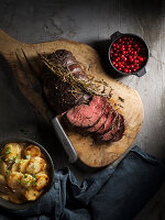 Oven-baked venison roast with pickled lingonberries and cream stewed artichokes