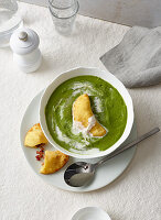 Wild garlic (ramp) soup with dumplings filled with bacon