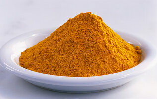 Ground turmeric on a plate